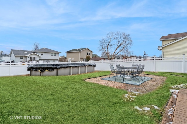 view of yard featuring a patio area and a covered pool