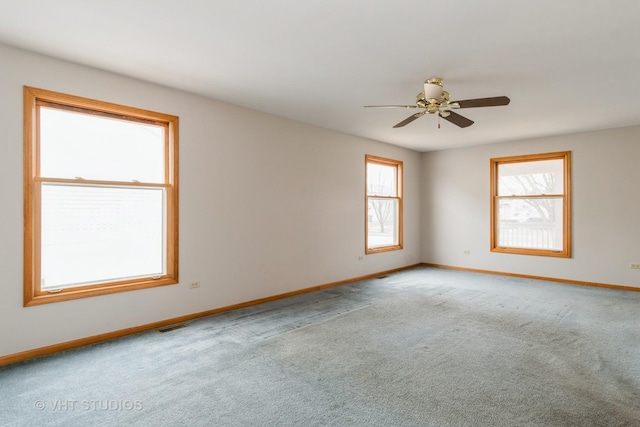 carpeted empty room featuring ceiling fan