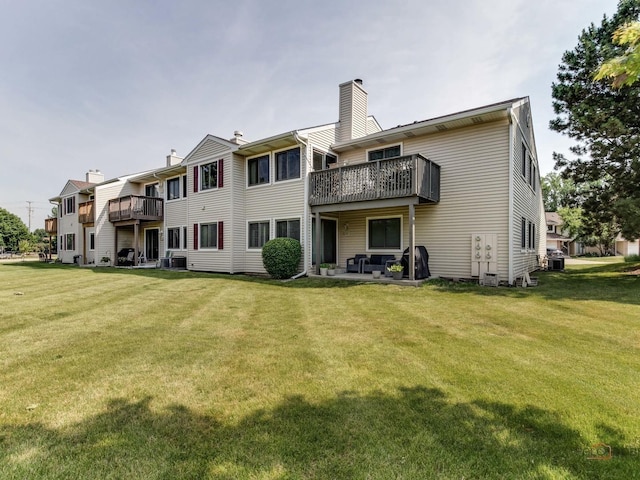 rear view of property featuring a yard