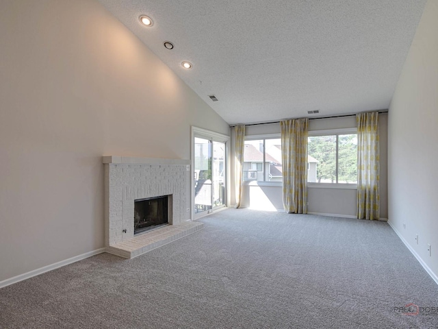 unfurnished living room featuring a fireplace, carpet floors, a textured ceiling, and high vaulted ceiling