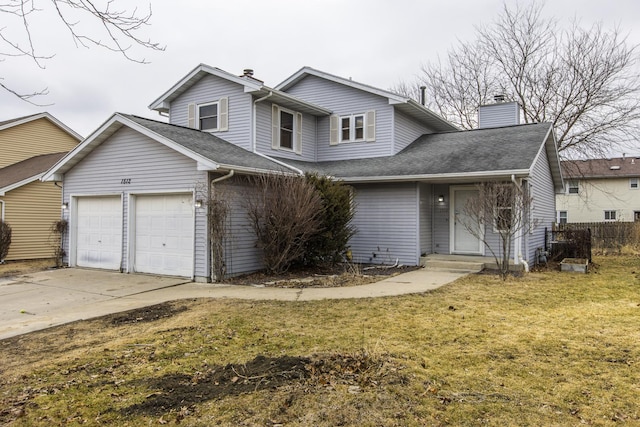 view of property featuring a garage and a front lawn