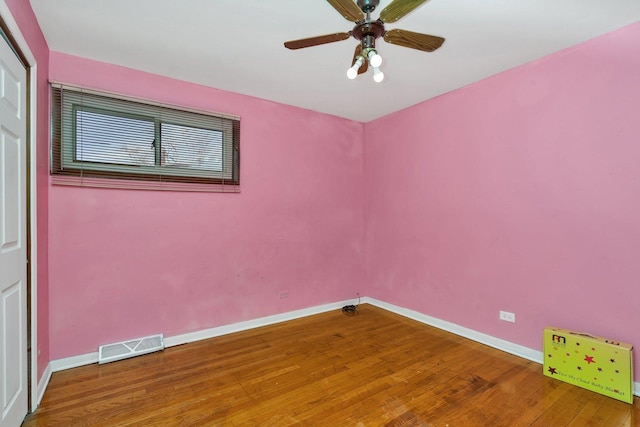 spare room featuring ceiling fan and hardwood / wood-style floors