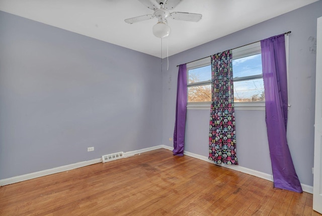 spare room with ceiling fan and light wood-type flooring