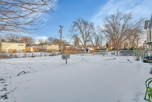 view of yard layered in snow