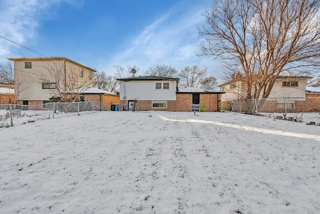 view of snow covered rear of property