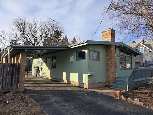 view of property exterior with a carport