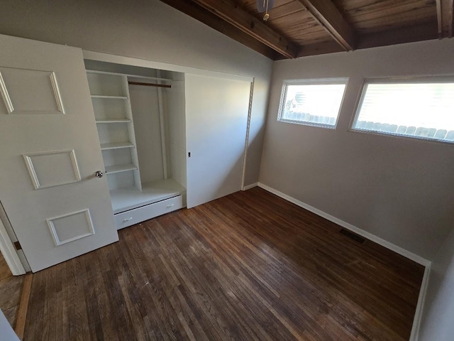 unfurnished bedroom featuring vaulted ceiling with beams, dark hardwood / wood-style floors, a baseboard radiator, wood ceiling, and a closet