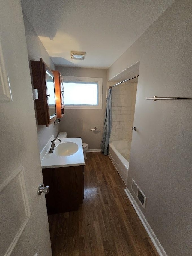 full bathroom featuring shower / tub combo with curtain, vanity, wood-type flooring, and toilet