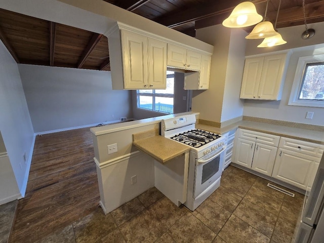 kitchen with white gas stove, kitchen peninsula, pendant lighting, white cabinets, and wood ceiling