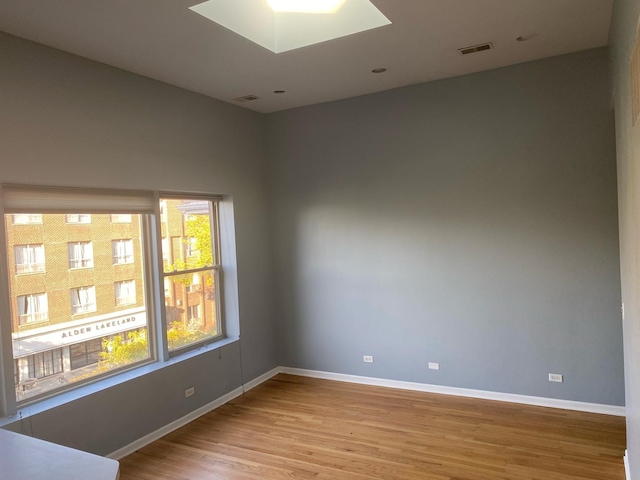 unfurnished room with light wood-type flooring