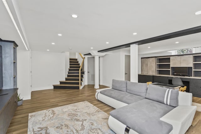 living room with hardwood / wood-style flooring and beamed ceiling