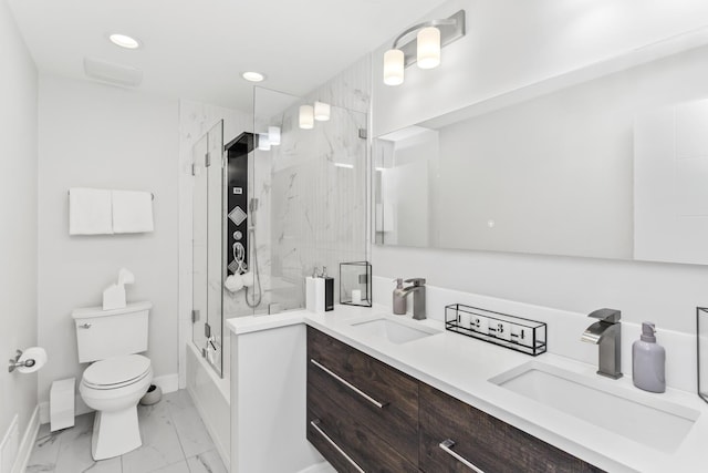 full bathroom with shower / bath combination with glass door, vanity, and toilet