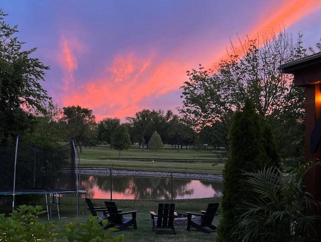 surrounding community featuring a water view, a yard, and a trampoline