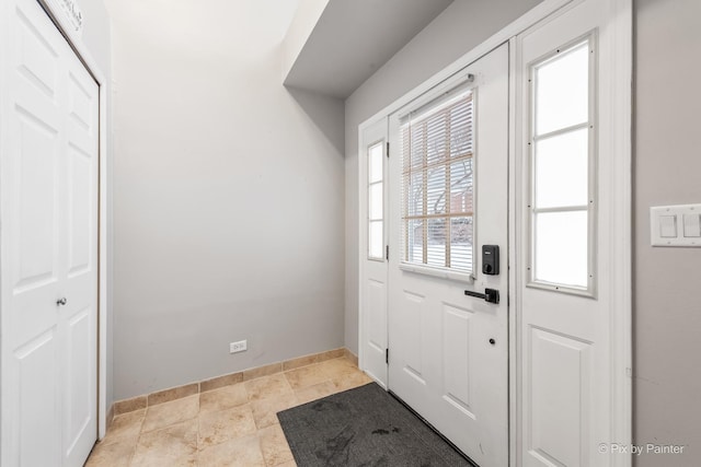 doorway to outside featuring light tile patterned floors