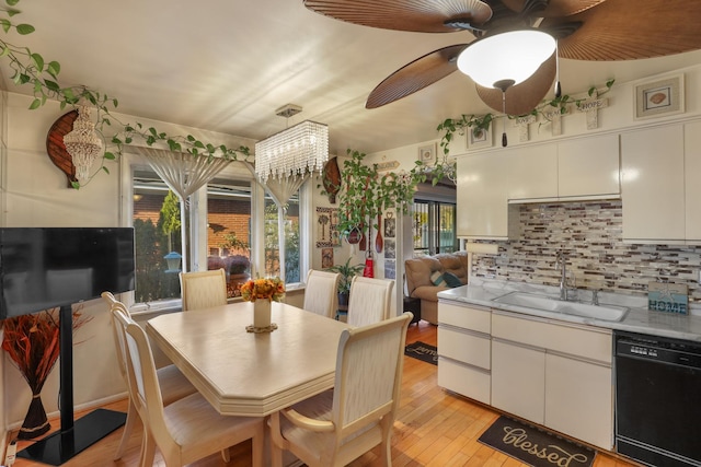 dining room featuring ceiling fan, sink, and light hardwood / wood-style flooring