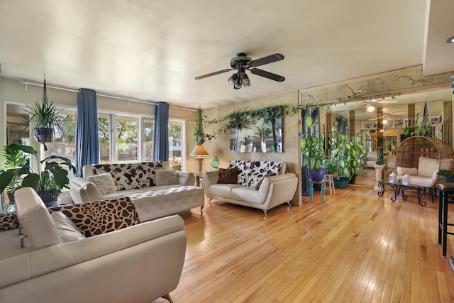 living room with ceiling fan and light wood-type flooring