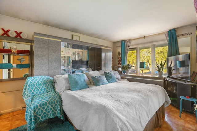 bedroom featuring parquet flooring