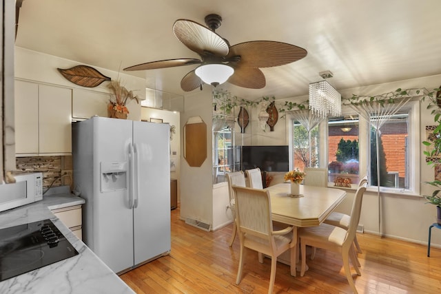 kitchen featuring decorative backsplash, white appliances, ceiling fan, light hardwood / wood-style flooring, and white cabinetry