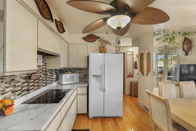 kitchen featuring white cabinetry, ceiling fan, white appliances, decorative backsplash, and light wood-type flooring