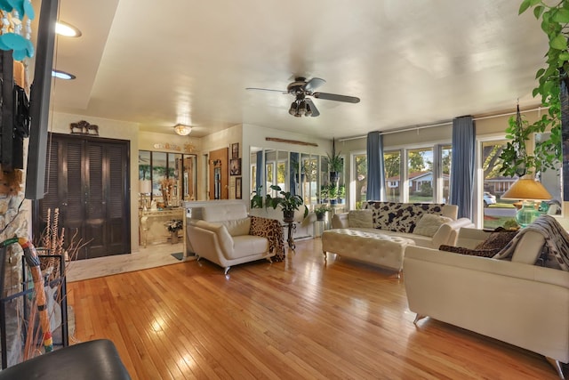 living room with ceiling fan and light hardwood / wood-style floors