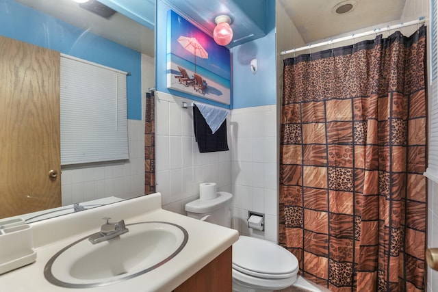 bathroom with vanity, toilet, tile walls, and curtained shower