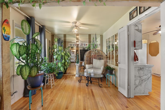 interior space with ceiling fan