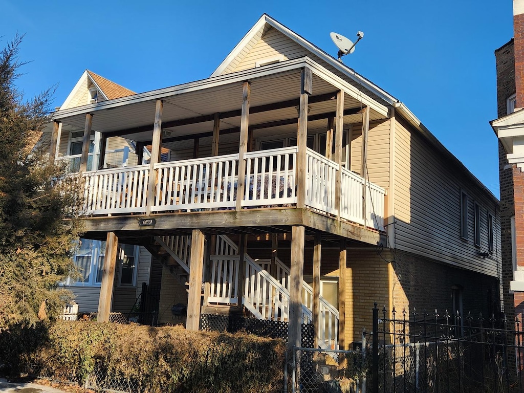 back of property with a wooden deck