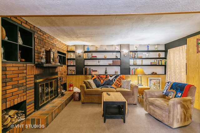 carpeted living room with built in features, a brick fireplace, and a textured ceiling