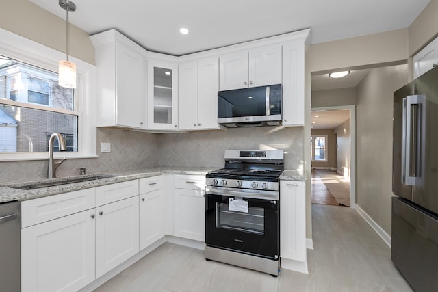 kitchen with sink, white cabinets, and appliances with stainless steel finishes