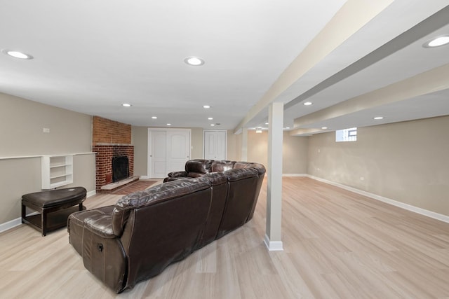 living room featuring a fireplace and light wood-type flooring