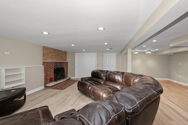 living room featuring a fireplace and light hardwood / wood-style floors