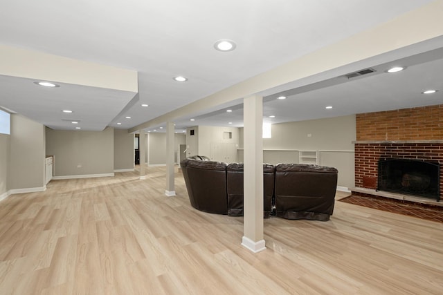 living room featuring a fireplace and light hardwood / wood-style flooring