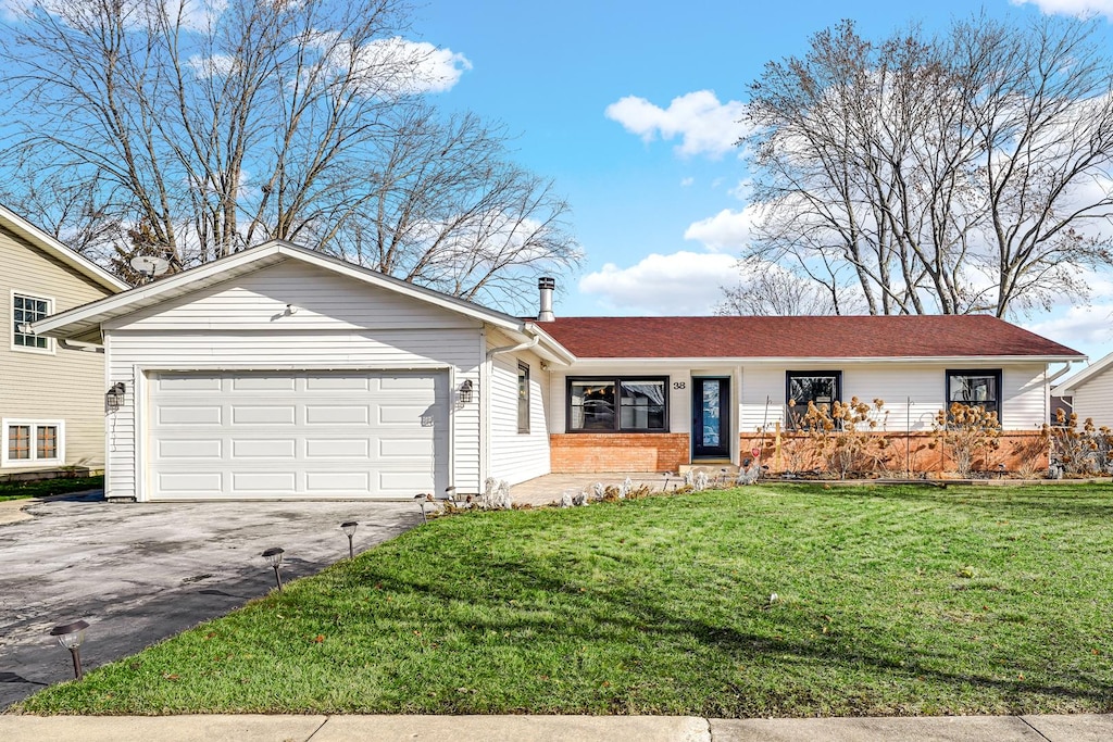 ranch-style house with a front yard and a garage