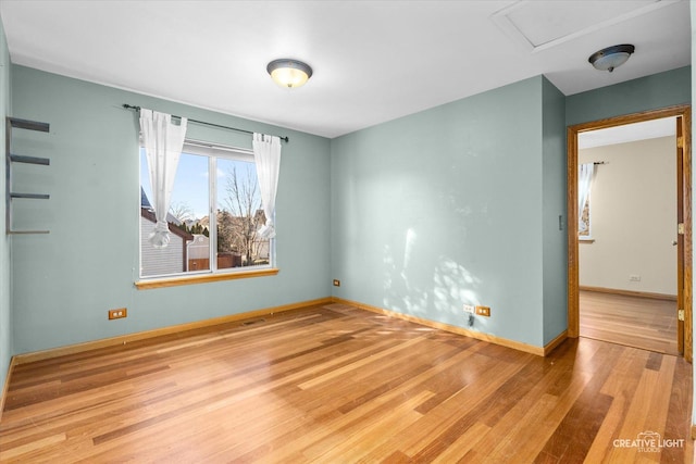 spare room with light hardwood / wood-style flooring