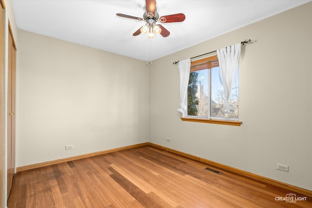 spare room with ceiling fan and wood-type flooring