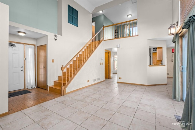 tiled foyer entrance featuring a high ceiling