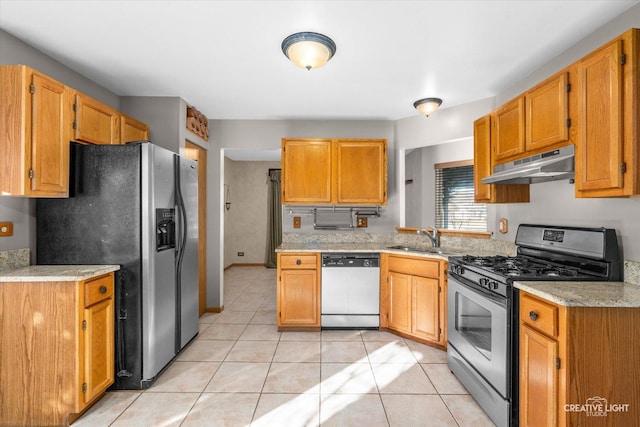 kitchen with gas stove, white dishwasher, sink, light tile patterned floors, and stainless steel fridge with ice dispenser