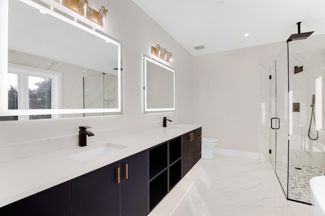 bathroom featuring a shower with door, vanity, and toilet