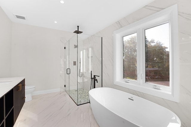 full bathroom featuring vanity, toilet, plenty of natural light, and separate shower and tub