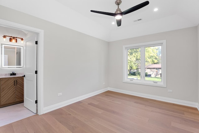 interior space with ceiling fan, a raised ceiling, and light hardwood / wood-style flooring