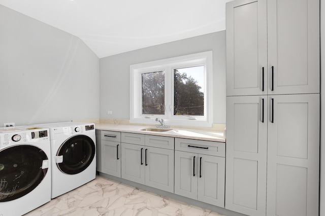 clothes washing area featuring cabinets, separate washer and dryer, and sink