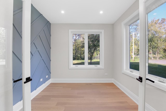 spare room with light hardwood / wood-style flooring