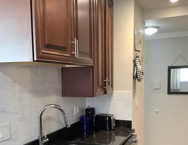 kitchen featuring dark stone countertops and backsplash