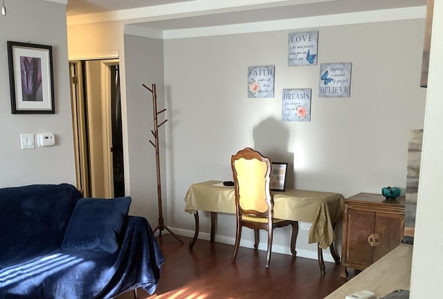 sitting room with dark hardwood / wood-style flooring and crown molding