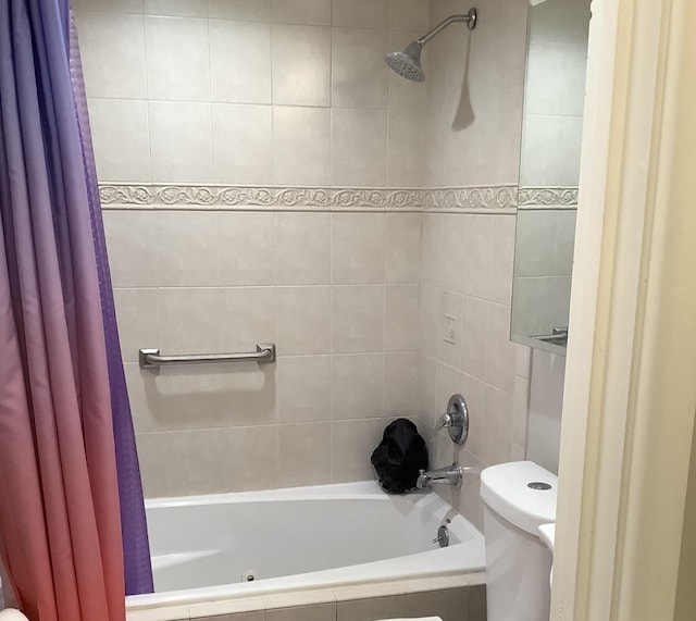 bathroom featuring shower / tub combo and toilet