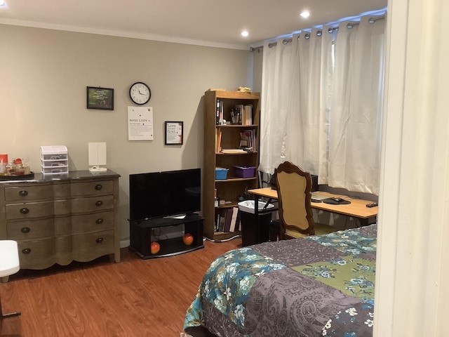 bedroom with crown molding and hardwood / wood-style flooring