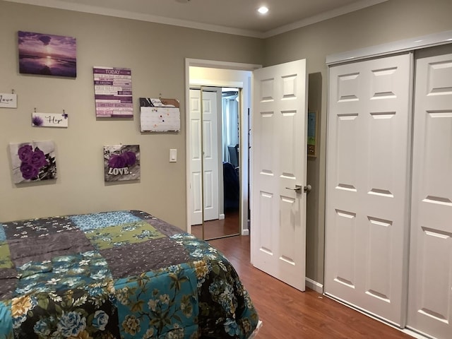 bedroom with hardwood / wood-style floors and ornamental molding