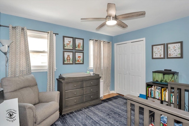 living area featuring ceiling fan and dark hardwood / wood-style floors