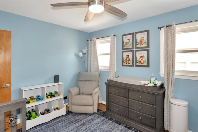 sitting room featuring ceiling fan and dark hardwood / wood-style floors