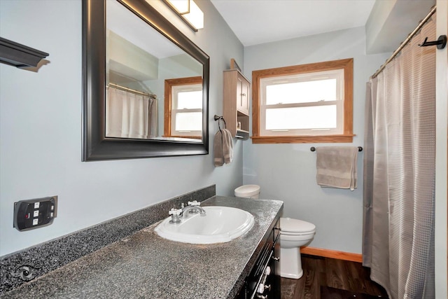 bathroom featuring hardwood / wood-style floors, vanity, and toilet